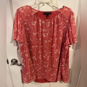 Short sleeve sheer light pink blouse.